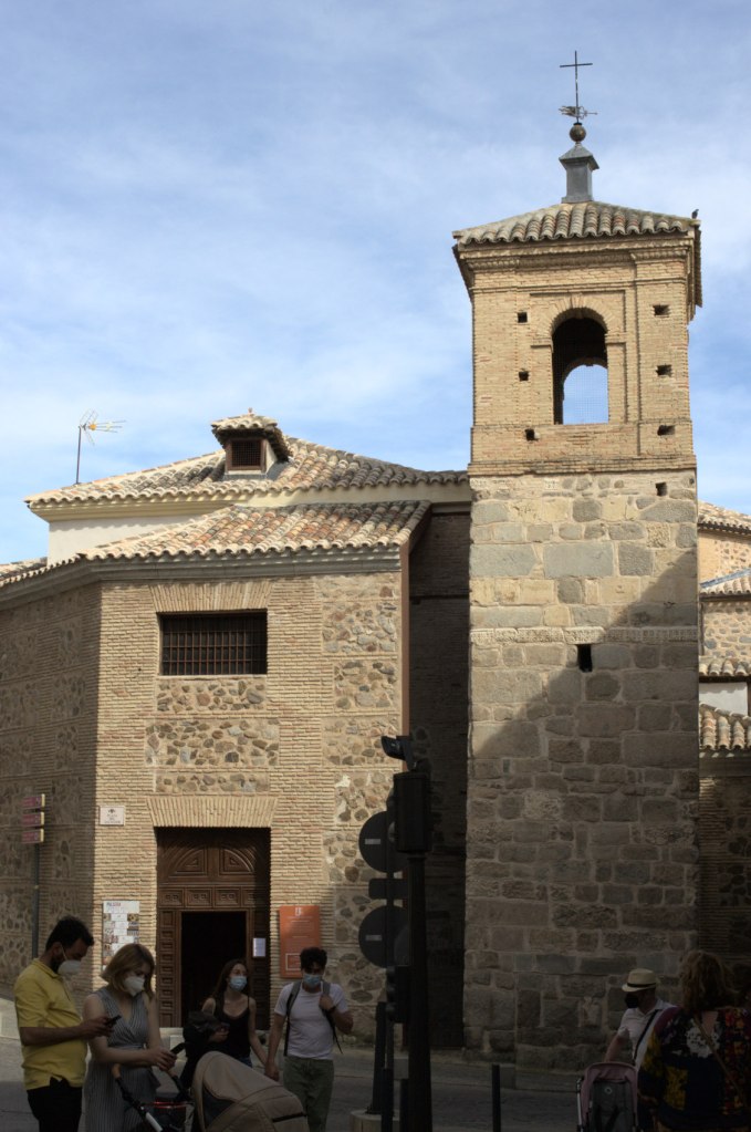 Церковь Сан-Сальвадор с башней-колокольней. На ближнем плане: люди, в том числе с детскими колясками.