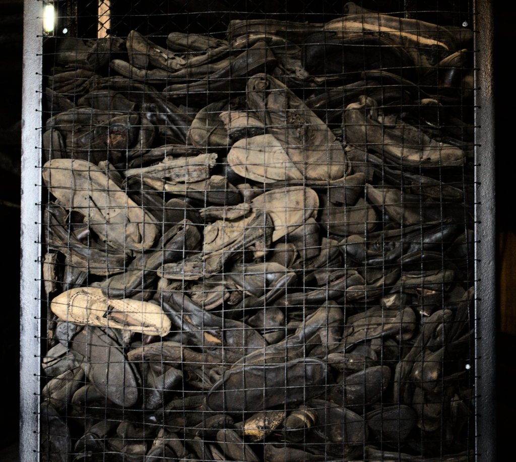 Много кожаной обуви в контейнере из металлической сетки